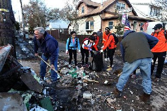 Community members and volunteers help clear out debris