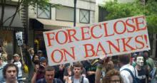 Occupy Philly protesters holding sign that reads, "Foreclose on Banks."