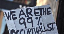 Photo: Handmade sign reading, "We Are the 99%. Occupy Wall Street."