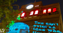 Photo of Cooper Union building with projection that reads, "you can't evict an idea whose time has come" 