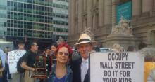 Couple holding "Do it for your kids" sign