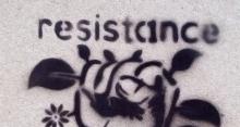 Photo of stencil illustration on wall that reads, "Resistance is fertile."