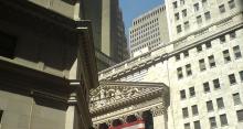 The American flag on the NYSE is obscured by shadow