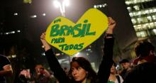 A woman holds up a heart-shaped sign that reads in Portuguese “One Brazil for all,” on Paulista Avenue where crowds gathered to celebrate the reversal of a fare hike on public transportation, in Sao Paulo, Brazil, Thursday, June 20, 2013. (Flickr/Sebástian Freire)