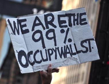 Photo: Handmade sign reading, "We Are the 99%. Occupy Wall Street."