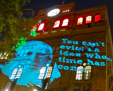 Photo of Cooper Union building with projection that reads, "you can't evict an idea whose time has come" 