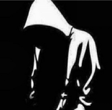 Silouette of person wearing hoodie.