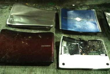 Photo of damaged laptops shown as evidence